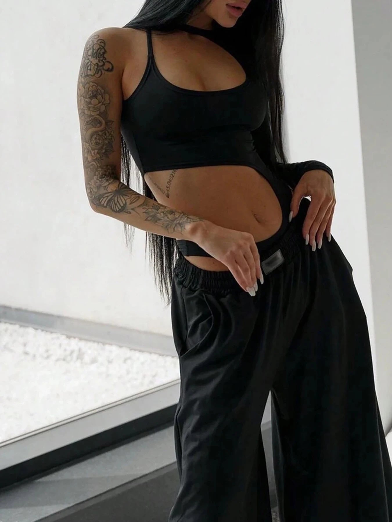 Black cutout bodysuit styled with wide-leg trousers