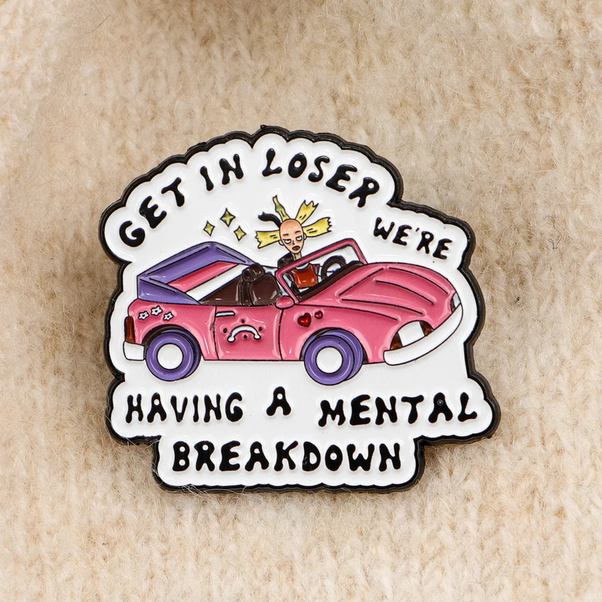 Enamel pin styled on knit fabric