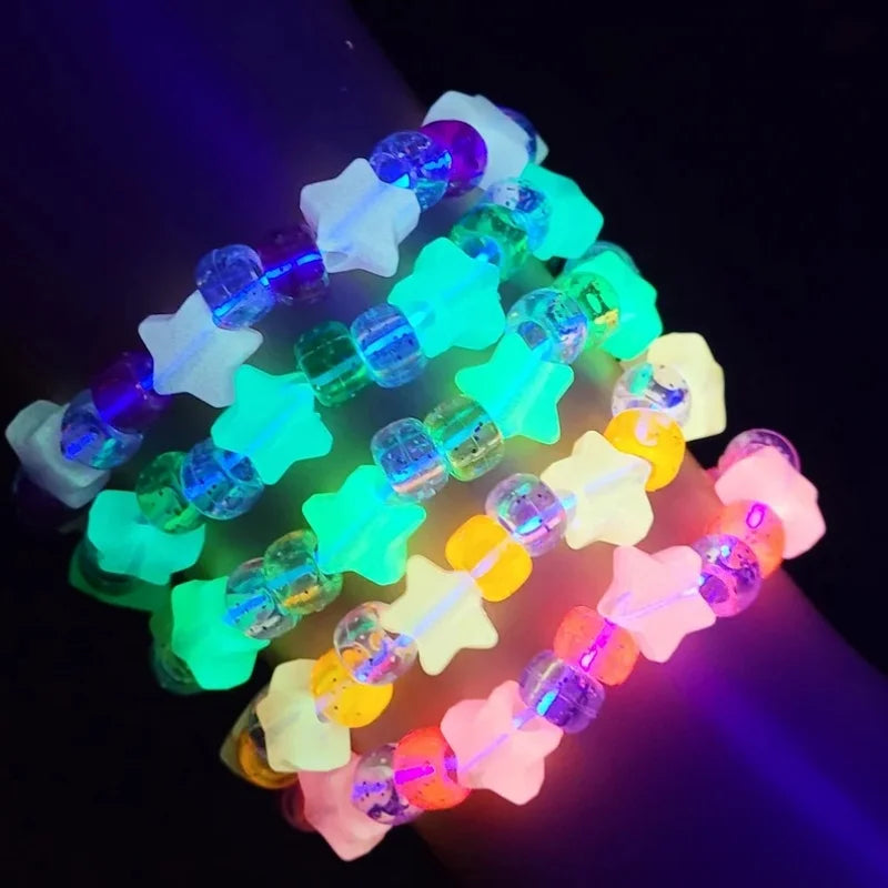 Star kandi bracelets glowing under blacklight