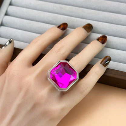 Magenta faceted cocktail ring worn