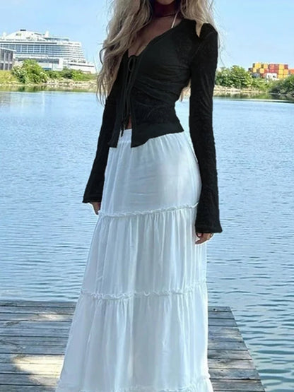 Full length view of the bell sleeve flocked rose top with a white maxi skirt