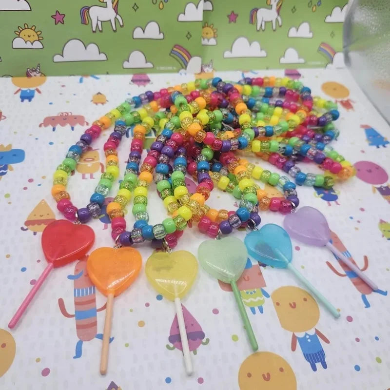 Rainbow kandi necklaces with jelly lollipop heart charms laid flat