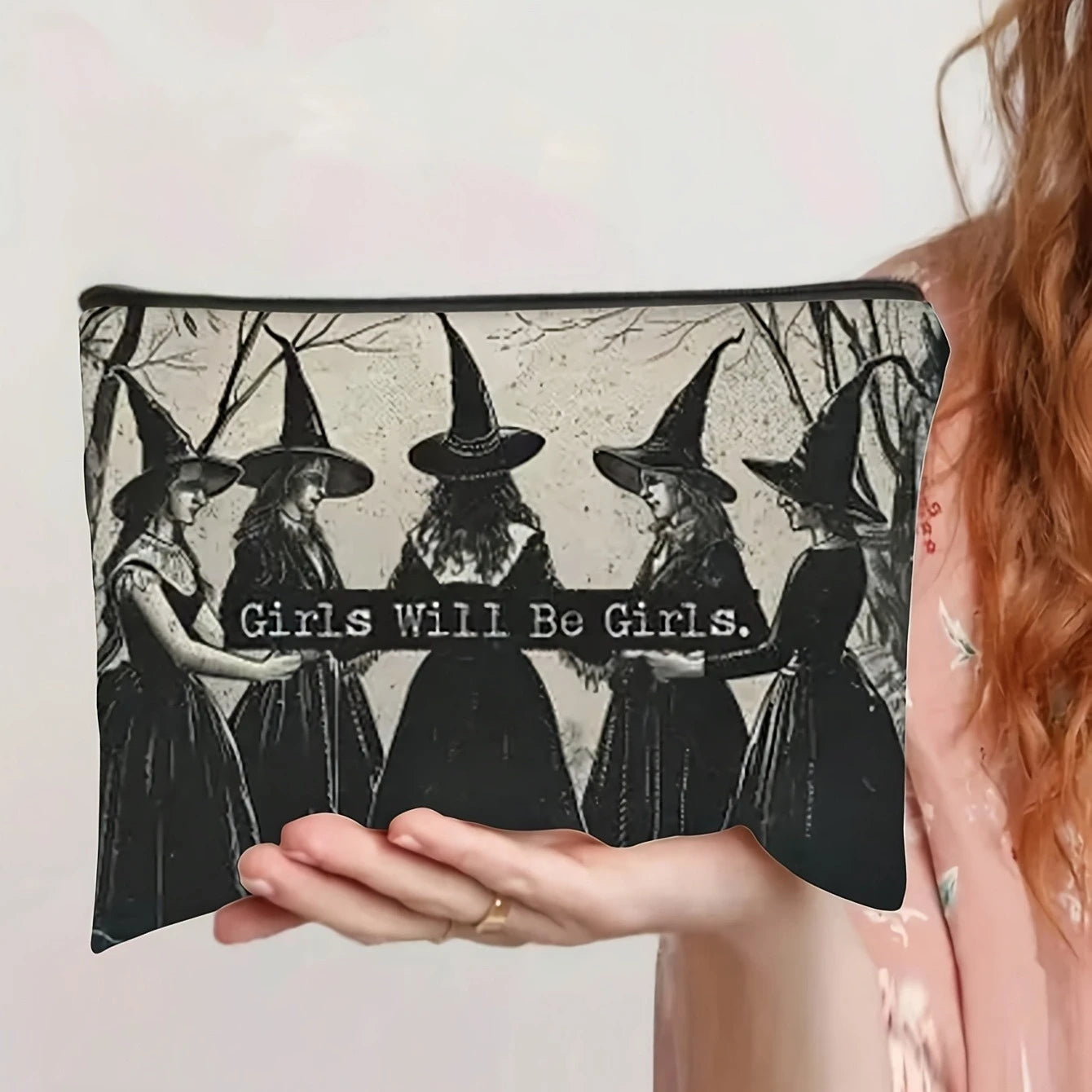 Witch print makeup pouch reading Girls Will Be Girls, front view