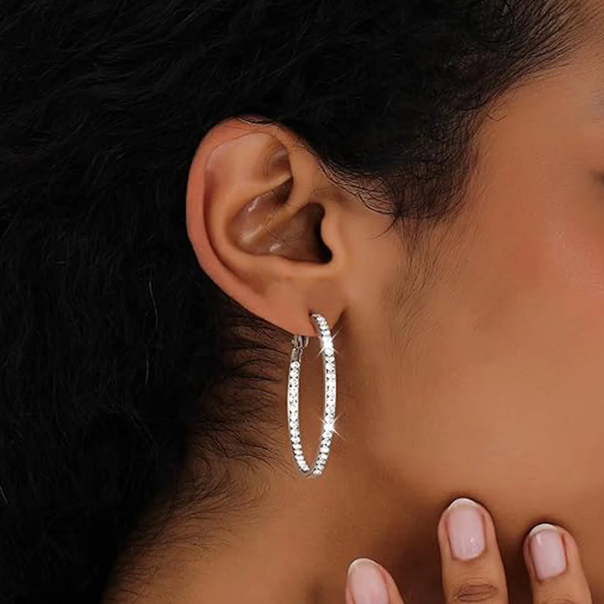 Rhinestone hoop earring worn on the ear
