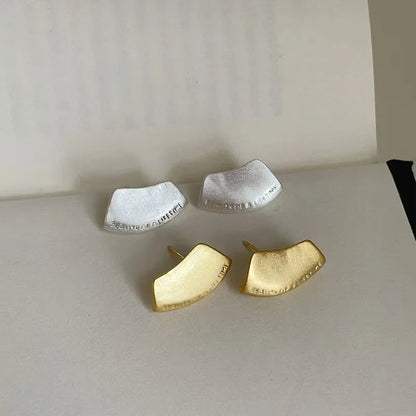 Brushed silver and gold sculptural stud earrings
