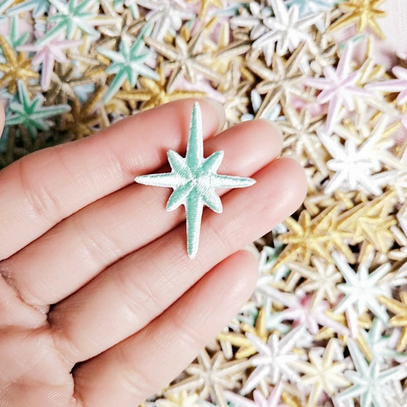 Mint embroidered star patch held in a hand