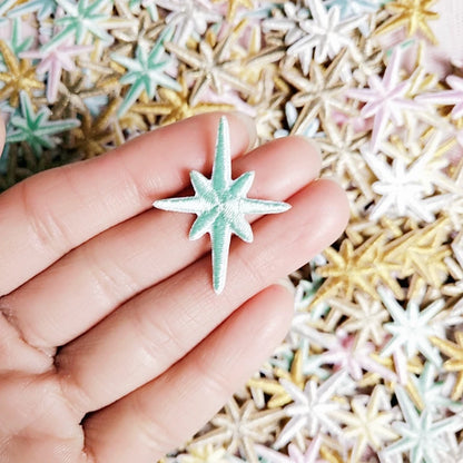 Mint embroidered star patch held in a hand