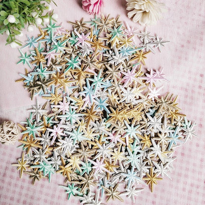 Pile of mixed pastel and metallic star patches