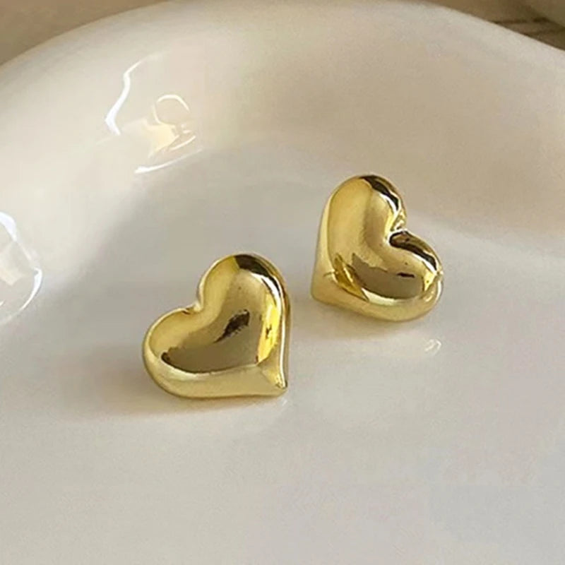 Gold tone puffed heart stud earrings
