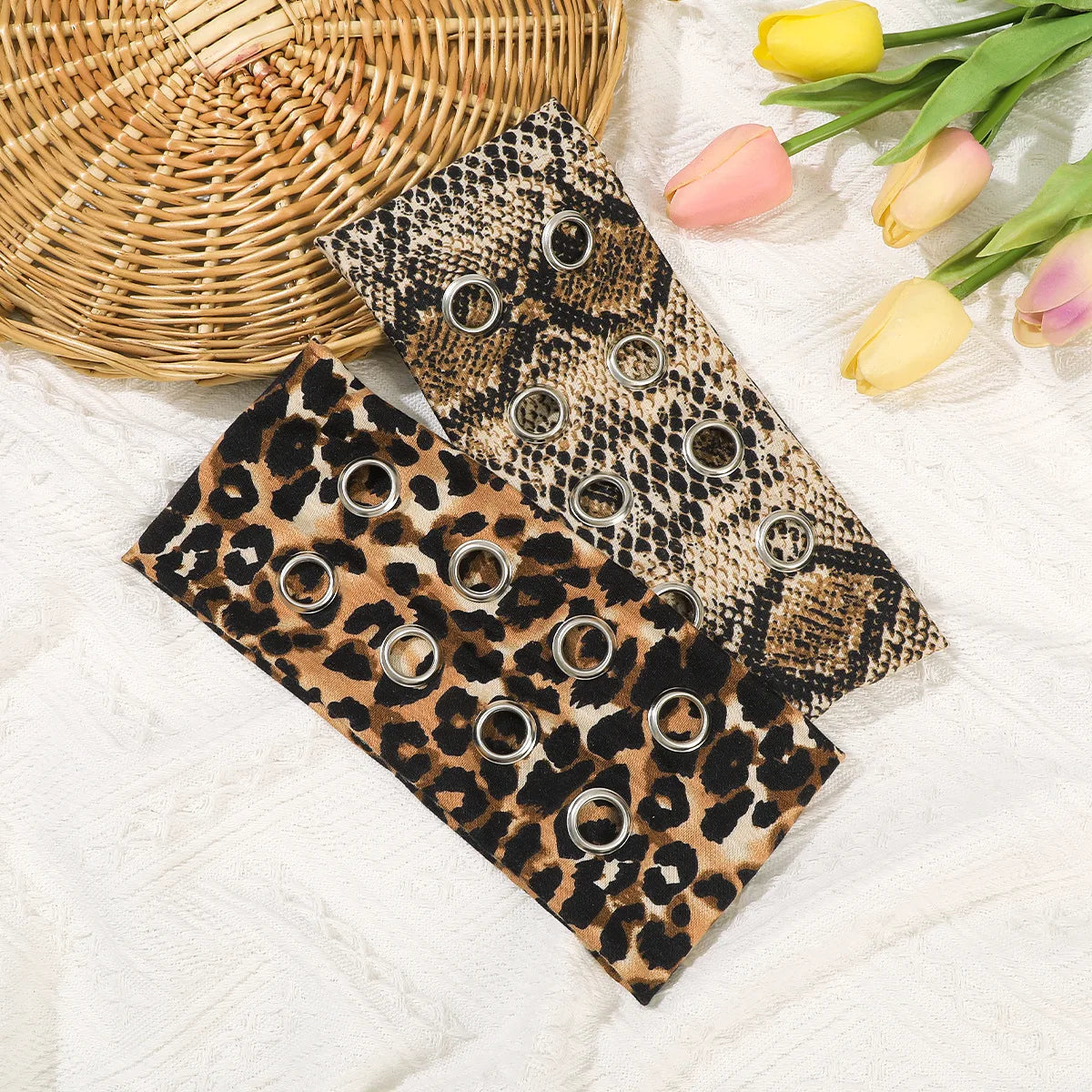 Leopard and snake print eyelet headbands laid flat