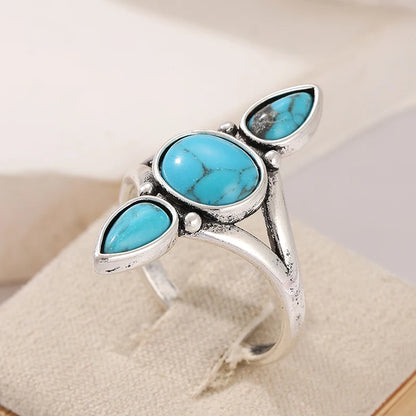 Close detail of the domed turquoise stones and silver-tone setting