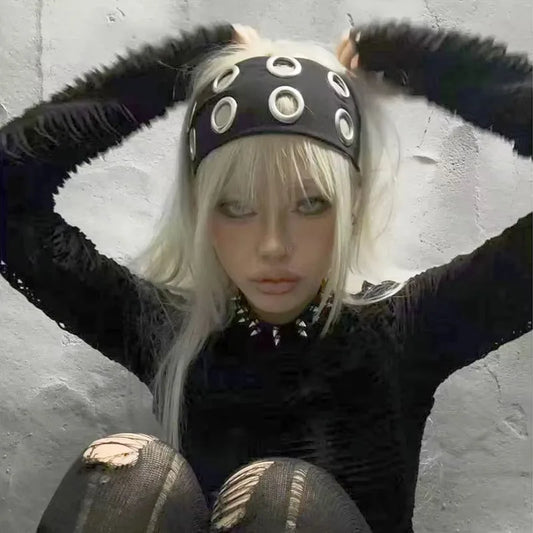 Model wearing black grommet stretch headband low across the brow