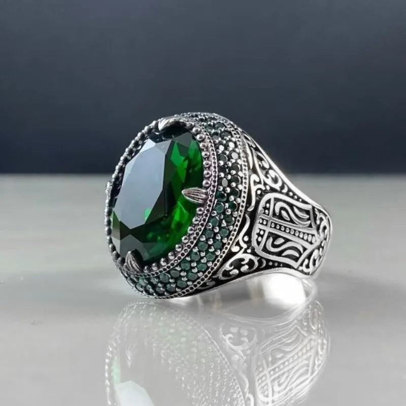 Ornate filigree signet ring with deep green oval stone