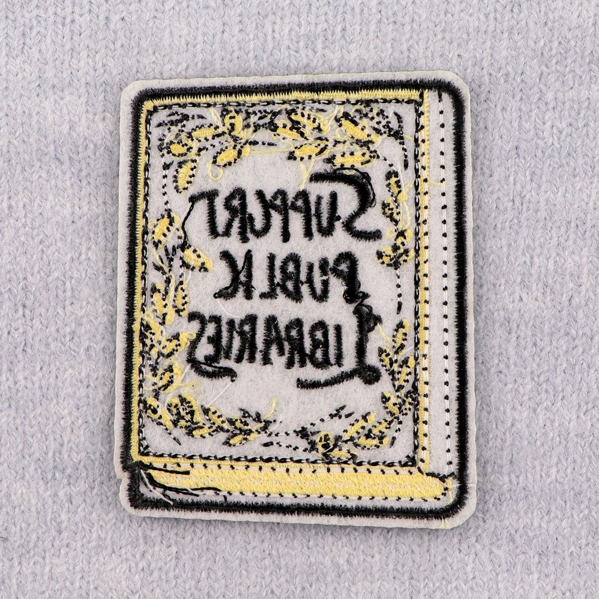 Reverse of the patch showing iron-on backing