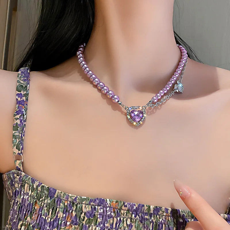 Pearl heart necklace worn at the throat