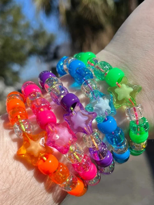 Rainbow kandi stretch bracelet stack with star beads worn on wrist