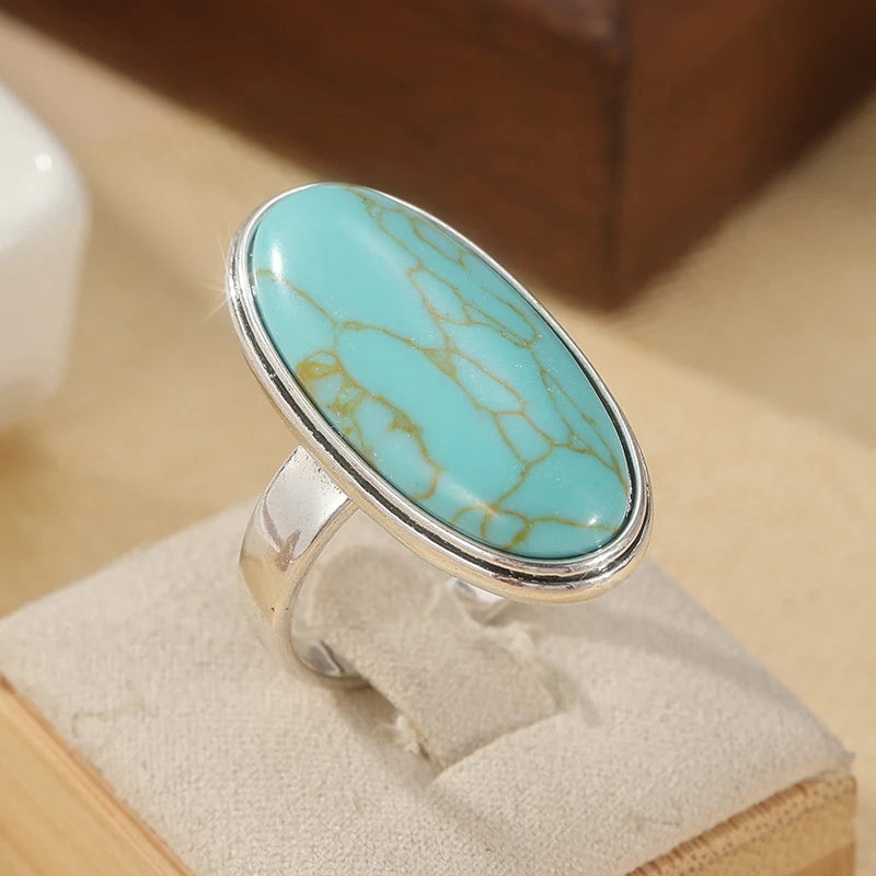 Faux turquoise oval ring on a light stand