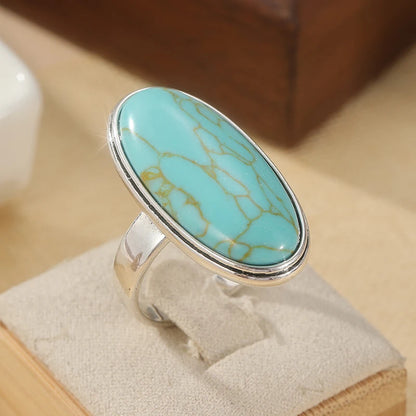 Faux turquoise oval ring on a light stand
