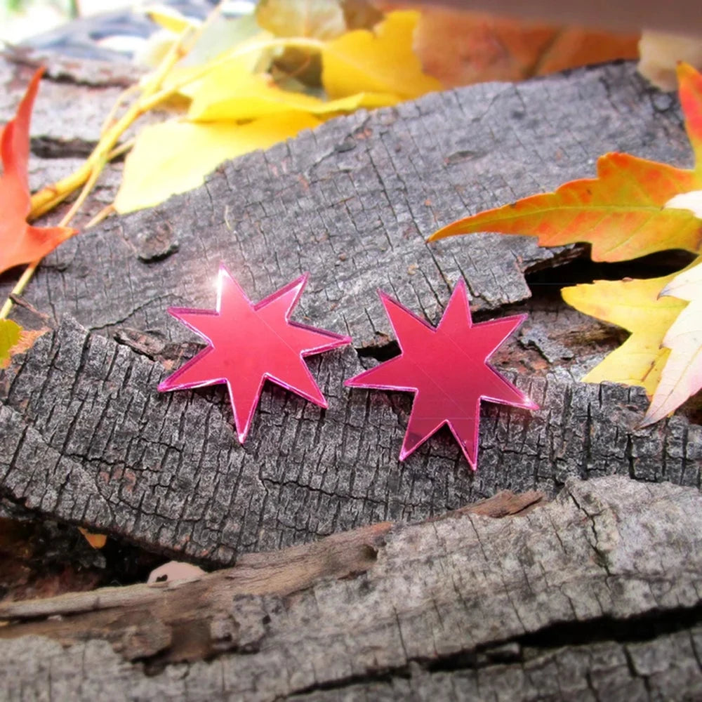 Detail of the mirrored pink finish on the star studs