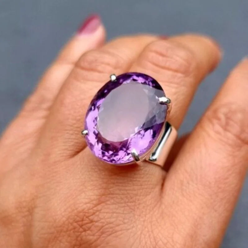 Purple oval statement ring worn on hand