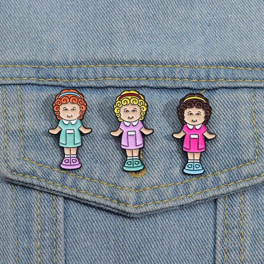 90s doll enamel pins on denim