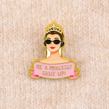 Enamel pin on a cream knit sweater