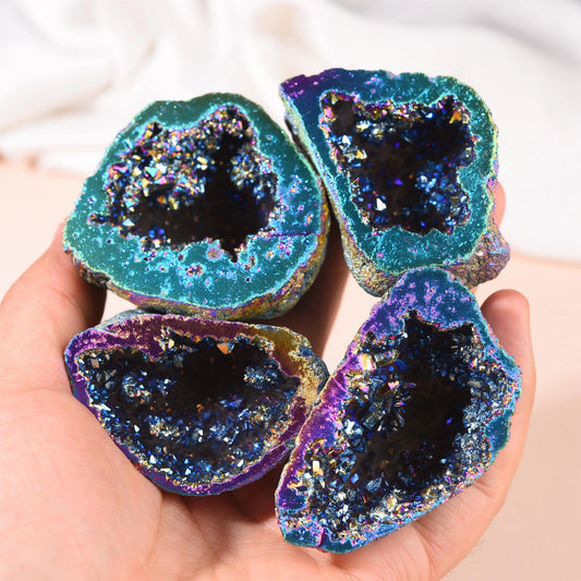 Four aura agate geodes held in a hand