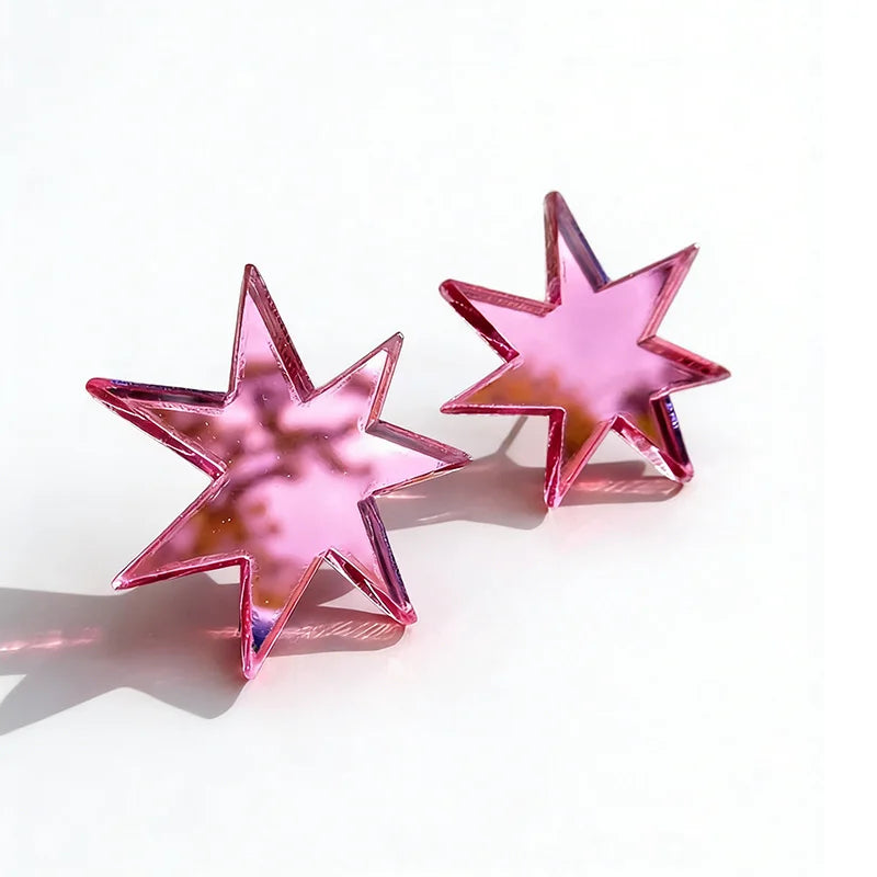 Pair of pink mirror acrylic star studs on white