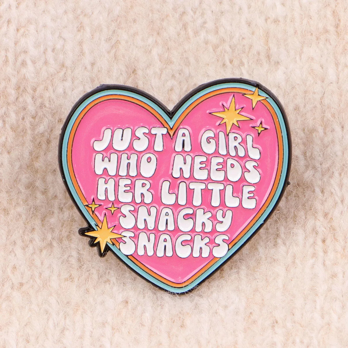 Snacky Snacks heart enamel pin on knit fabric