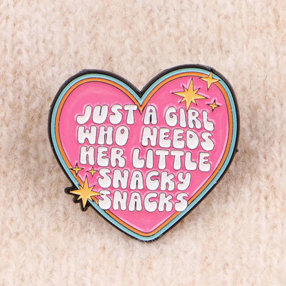Snacky Snacks heart enamel pin on knit fabric