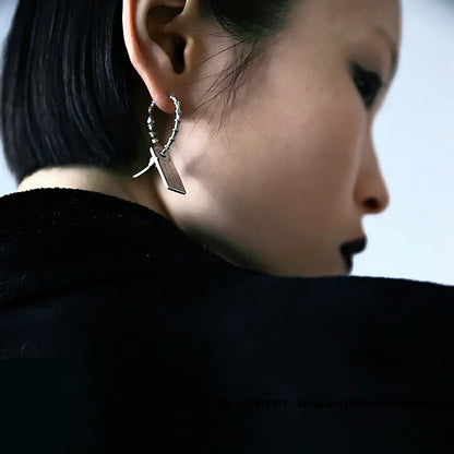 Buzzsaw cyber drop earring worn from behind