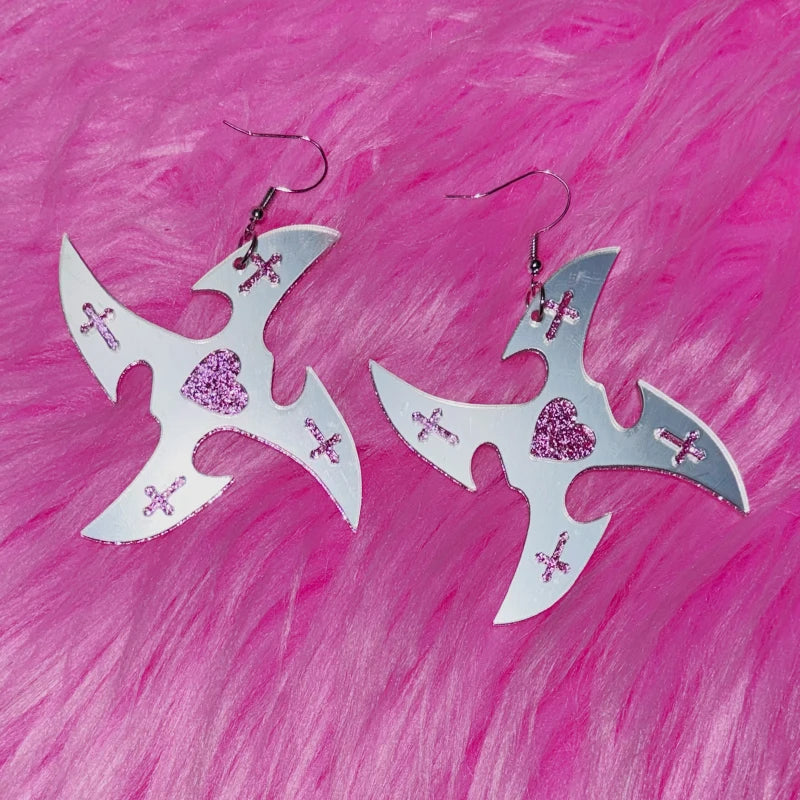 Mirror star earrings on pink fur