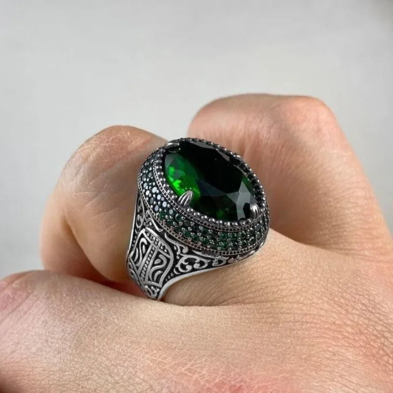 Green stone signet ring worn on the hand