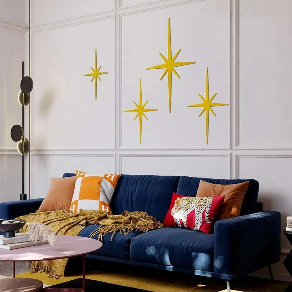 Matte gold atomic starburst metal wall set above a sofa