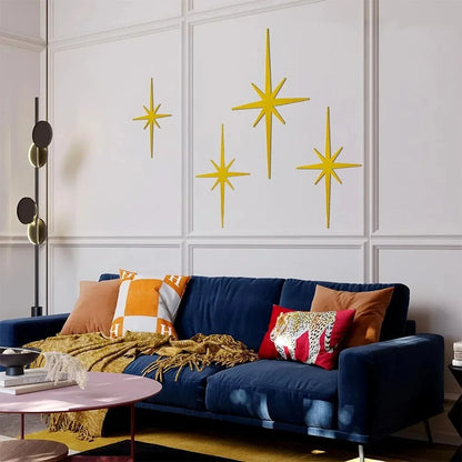 Matte gold atomic starburst metal wall set above a sofa