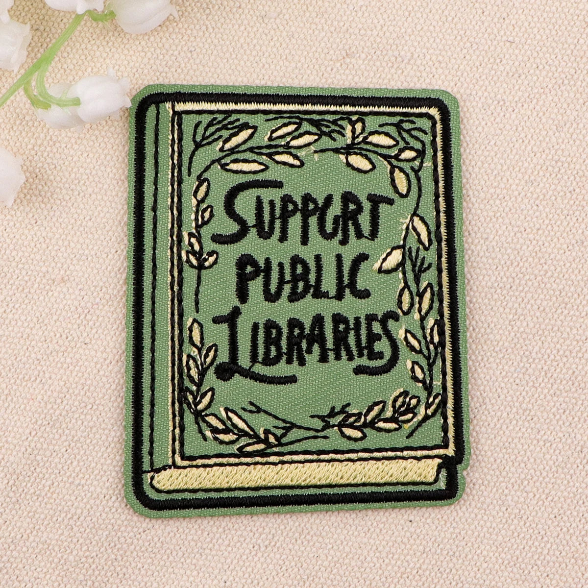 Sage green book patch styled flat lay