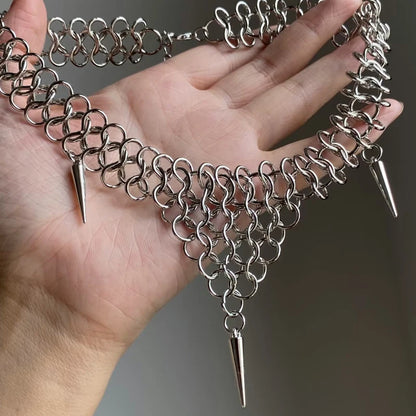 Chainmail spike collar held in hand