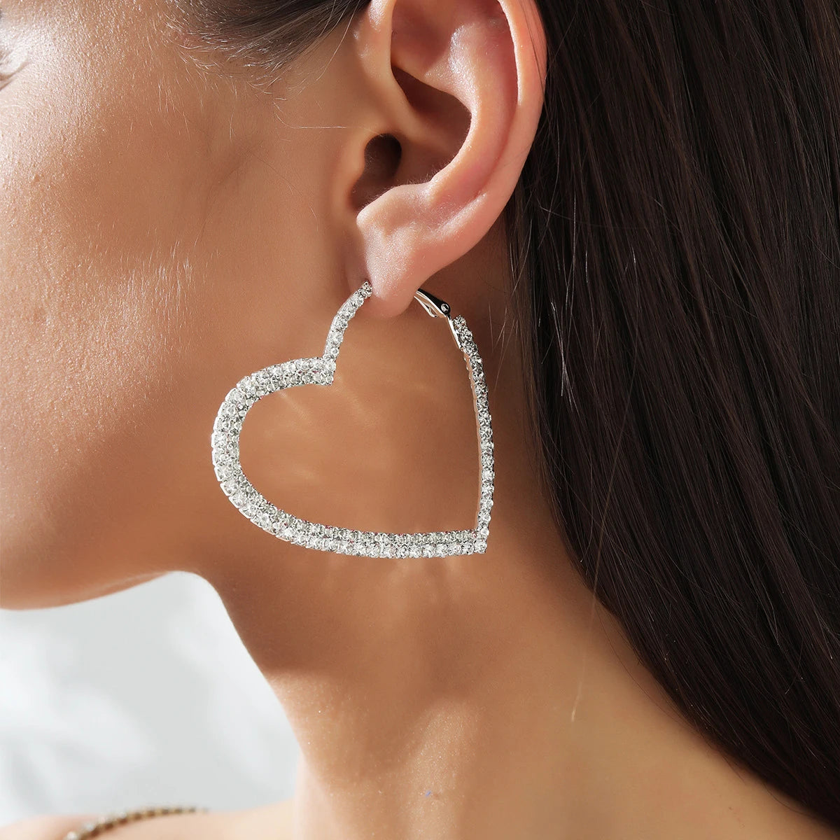 Model wearing a crystal heart hoop earring