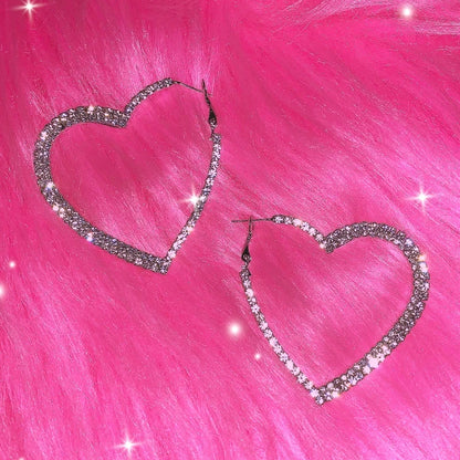 Crystal heart hoop earrings on pink faux fur