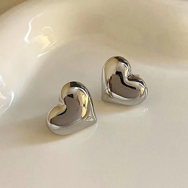 Silver tone puffed heart stud earrings