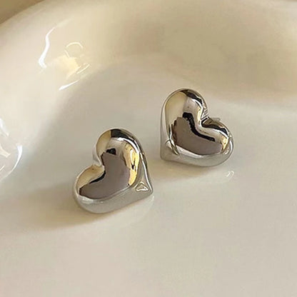 Silver tone puffed heart stud earrings