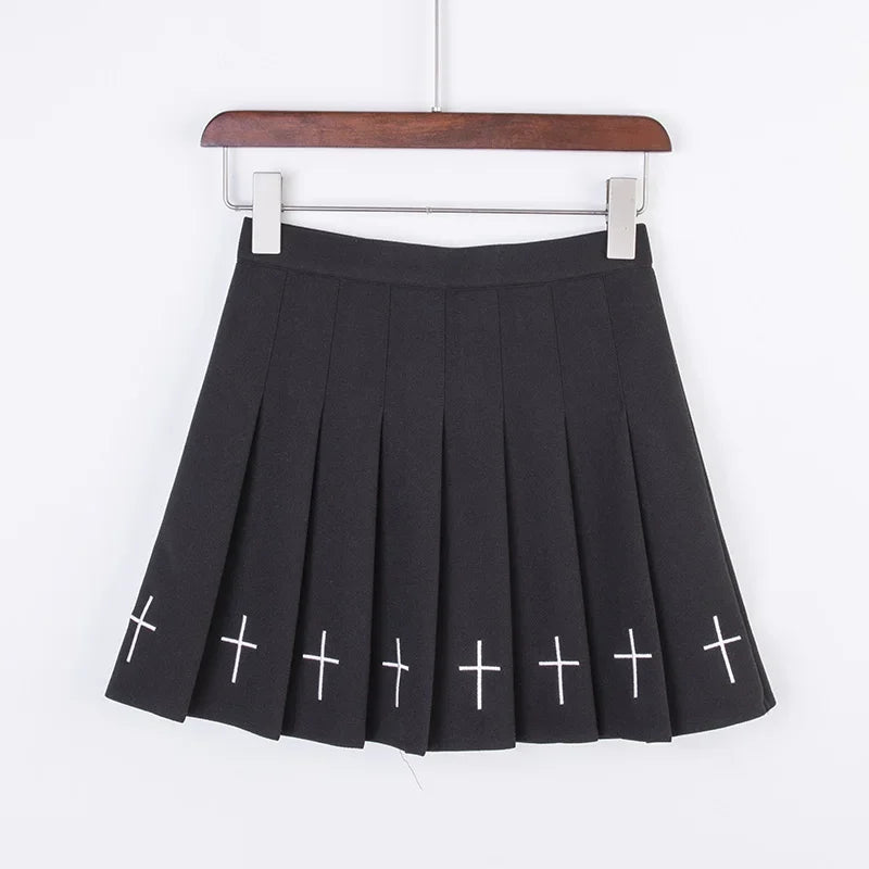 Black pleated mini skirt with white embroidered crosses