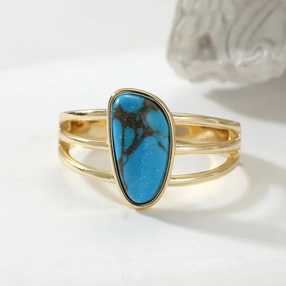 Deep Water freeform blue stone on a stacked gold-tone triple band
