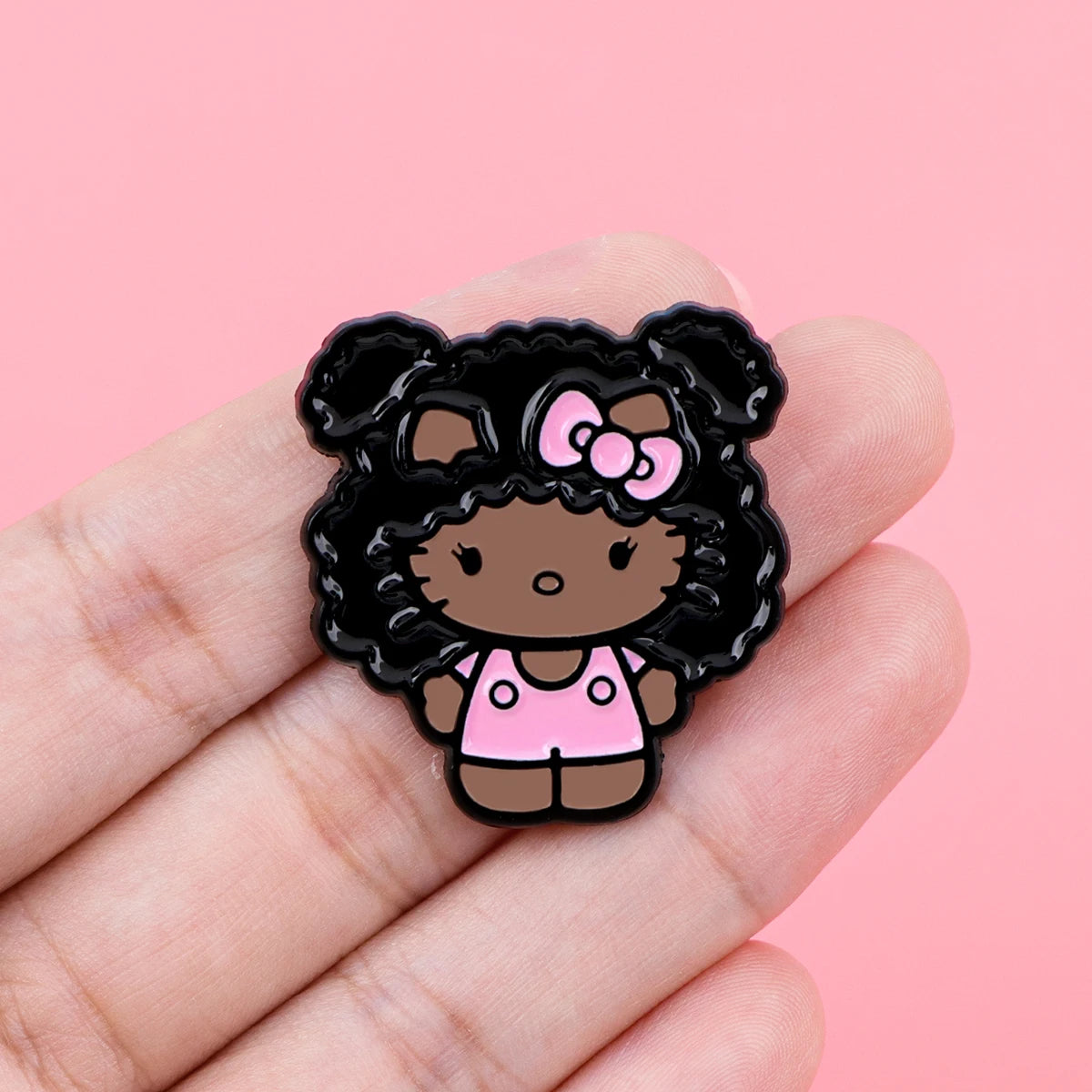 Enamel pin held in hand for scale