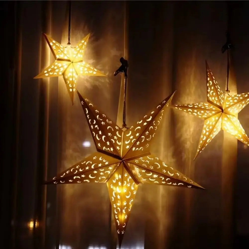 Paper star lantern glowing in a dark room