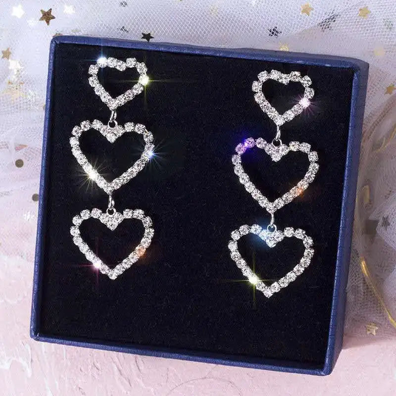 Triple heart crystal earrings presented in a gift box