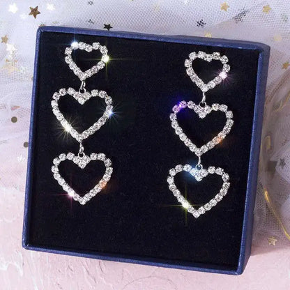 Triple heart crystal earrings presented in a gift box