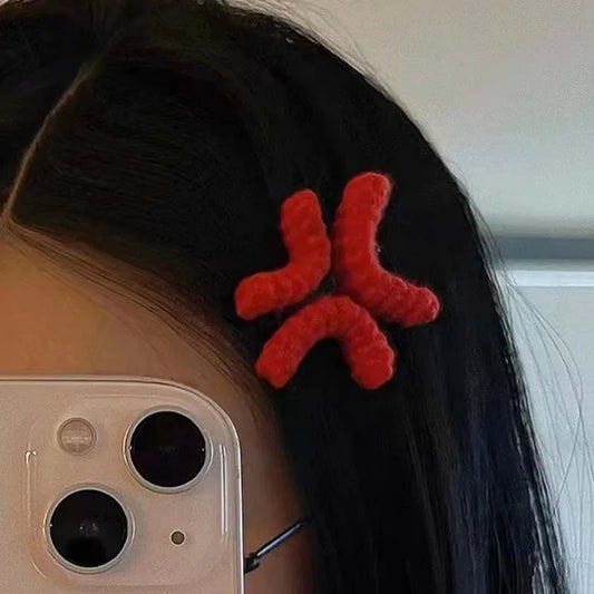 Red crochet anger mark hair clip worn at the temple