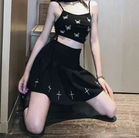 Cross print pleated skirt styled with a cropped top