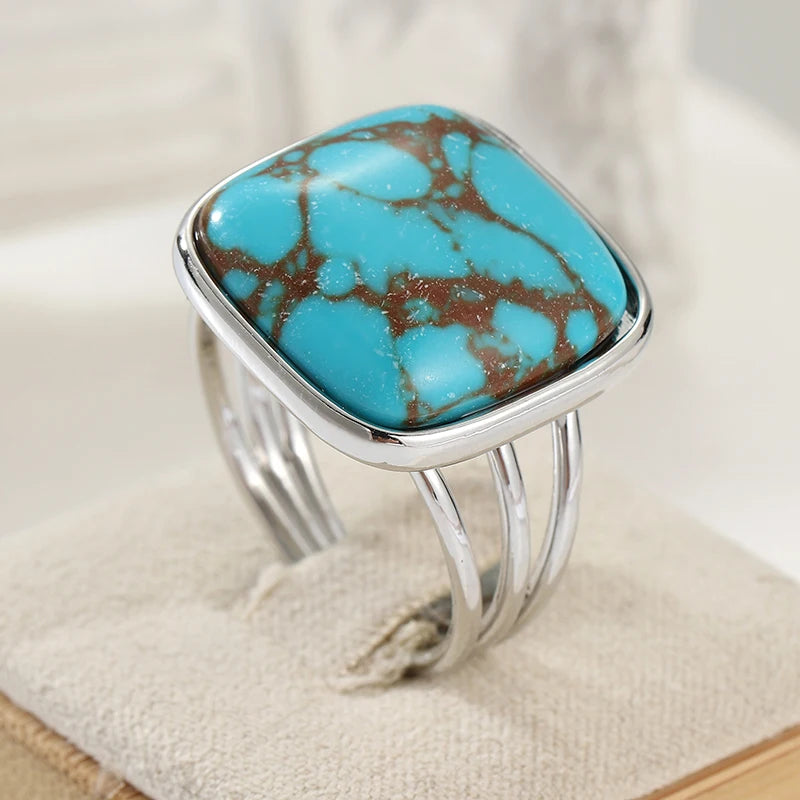 Cushion-cut faux turquoise ring on a split silver-tone band